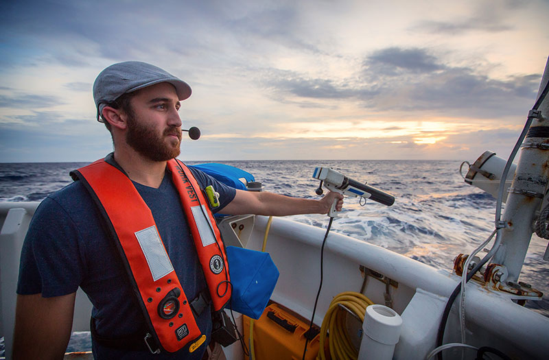 Deepwater Wonders of Wake expedition Mapping Watch Lead, Dan Freitas, conducts an XBT cast in order to correct mapping data for water column variability. Deepwater Wonders of Wake expedition Mapping Watch Lead, Dan Freitas, conducts an XBT cast in order to correct mapping data for water column variability.
