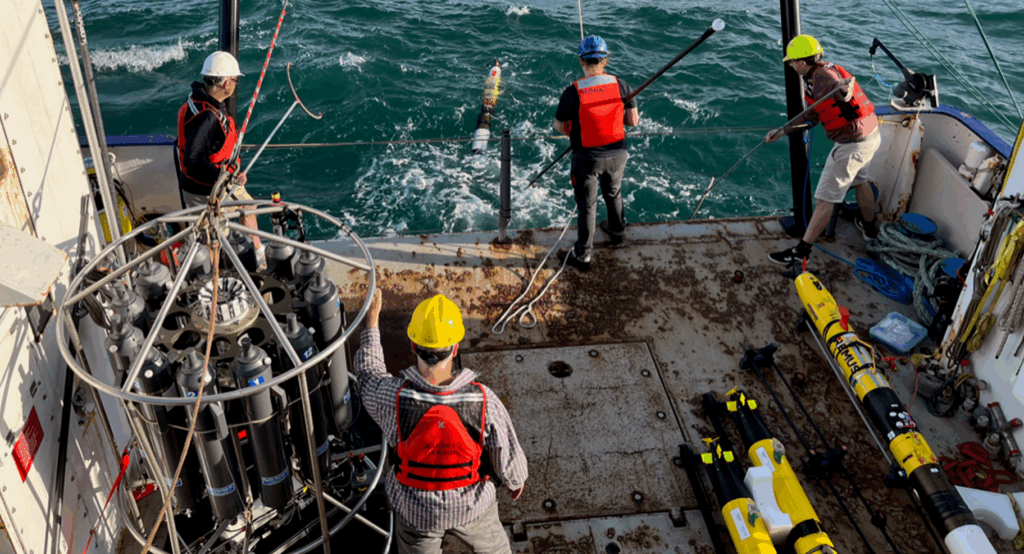 The project team deploying an autonomous underwater vehicle from the deck of Research Vessel Rachel Carson.