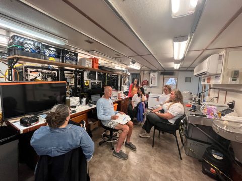 John Reed, co-chief scientist, addresses the science crew prior to a dive during Exploration of Deepwater Habitats off Puerto Rico and the U.S. Virgin Islands for Biotechnology Potential. Clockwise from left to right: Megan Conkling, John Reed, Carol Kim, Courtney Brooks, Cristina Diaz and Kirstie Francis.