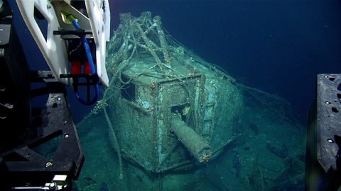 Image from ROV Deep Discoverer of the ship gun fire-control system with base of antenna array and with cylindrical range finder located above the pilot house. The ship gun fire control system is the highest point of the wreck. Image was taken from the starboard side of the Baldwin, facing port. Bow is orientated to the right of the image. Note the derelict fishing gear on the wreck.
