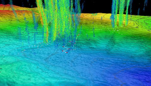 Three-dimensional perspective of a ROV Deep Discoverer dive track (white lines) and waypoints (red points) with superposed water column bubble plumes (multi-colored point clouds) imaged by NOAA Ship Okeanos Explorer during a previous mission. Methane bubble plumes at Norfolk Seeps have been imaged rising over 900 meters (2,950 feet) above the seafloor in previous surveys. Bathymetric data were collected with the Okeanos Explorer multibeam sonar and are contoured at 10-meter (about 3-feet) intervals. The locations of previously identified seeps are indicated with white points. All data shown at two times vertical exaggeration.
