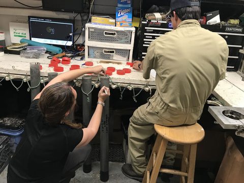 Dr. Amanda Evans in the ship’s lab writing field notes on each core sample.